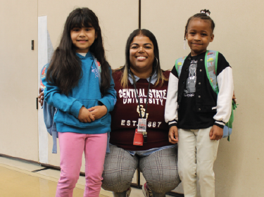 teacher standing with students